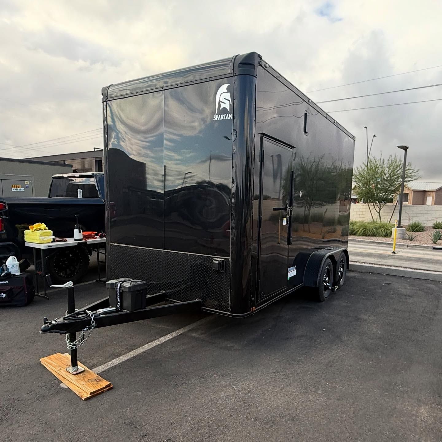 Black enclosed cargo trailer parked outdoors.