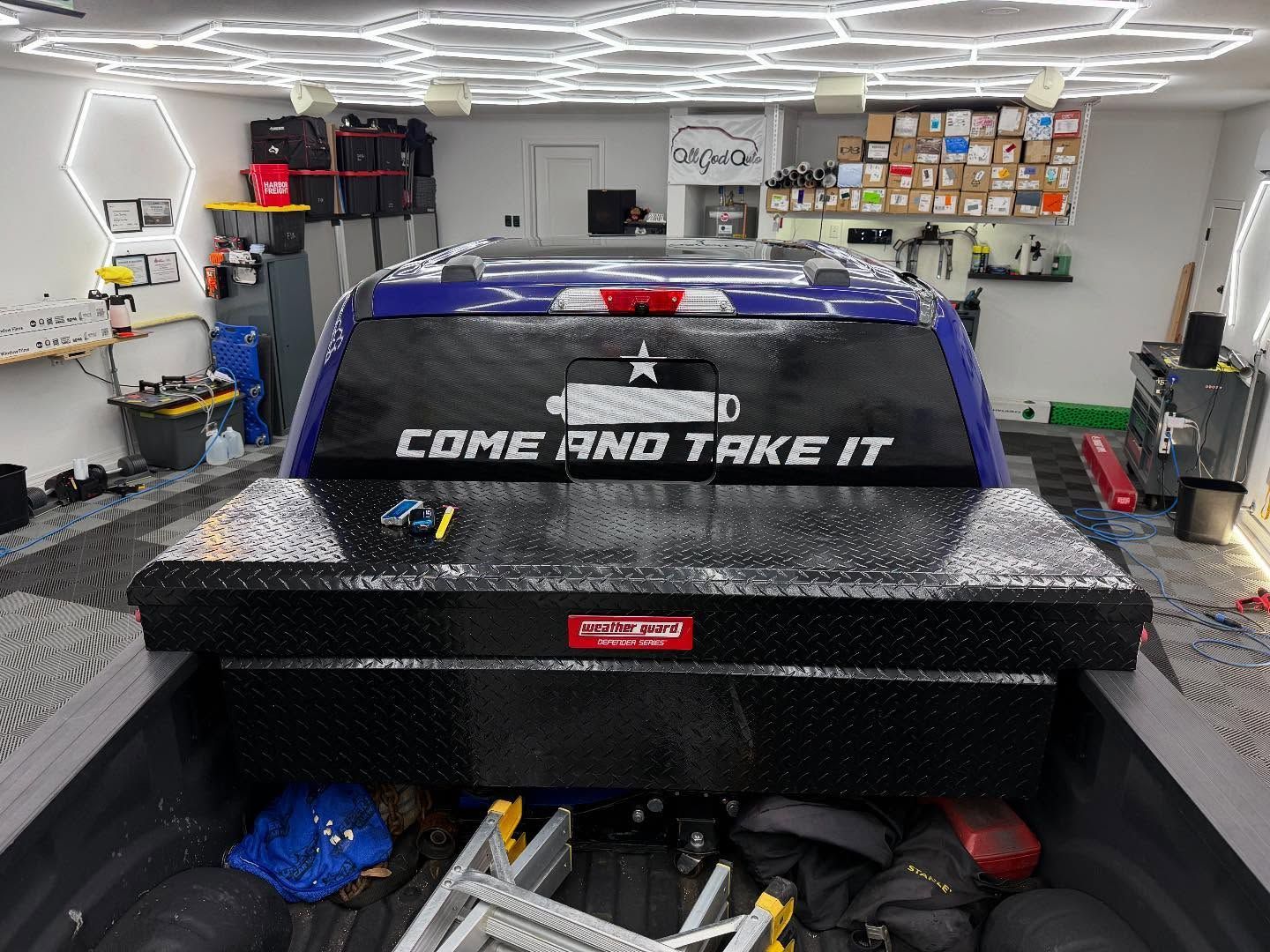 Blue pickup truck bed with a black toolbox, 