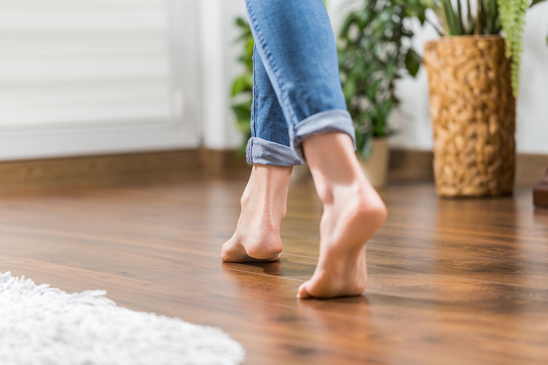 Woman Walking Barefoot on Wooden Floor
