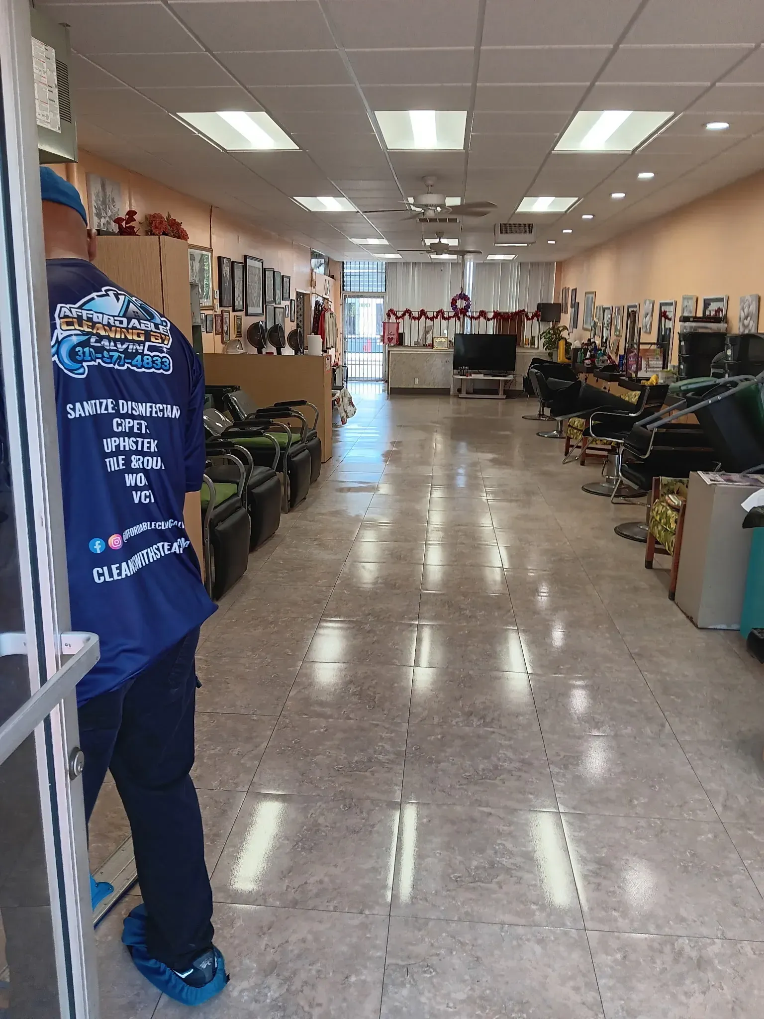 A woman is mopping the floor in a mall.