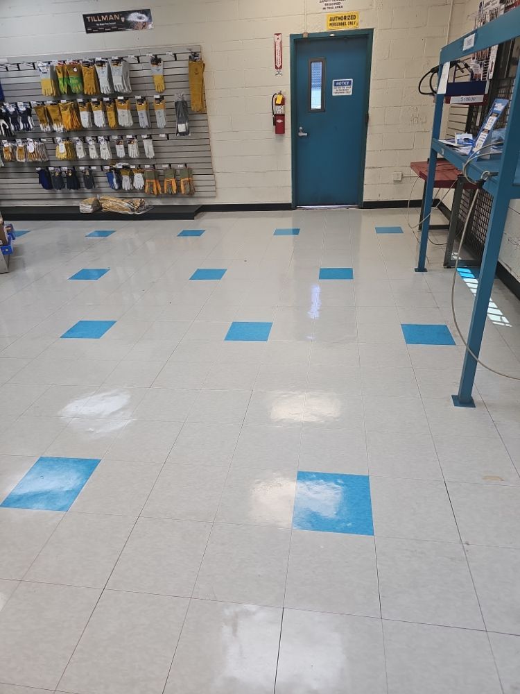 A room with blue tiles on the floor and a blue door.