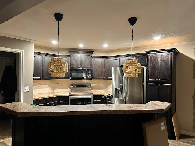 A kitchen with stainless steel appliances and wooden cabinets.