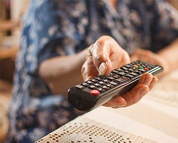 Man using a remote control — Gulf Shores, AL — Baldwin Hearing Center