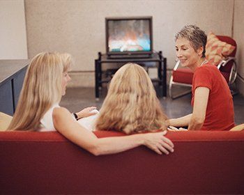 Family watching TV — Gulf Shores, AL — Baldwin Hearing Center