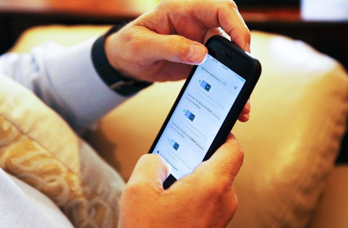 Man using phone — Gulf Shores, AL — Baldwin Hearing Center