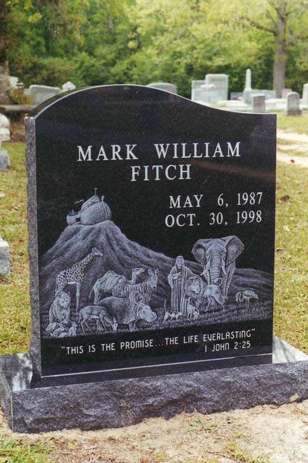 A gravestone for mark william fitch in a cemetery