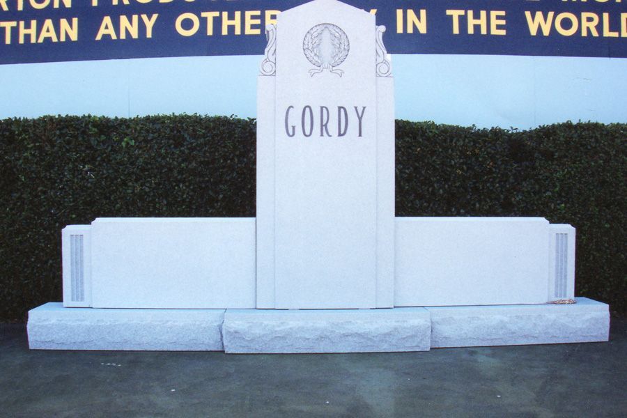A white monument with the name gordy on it