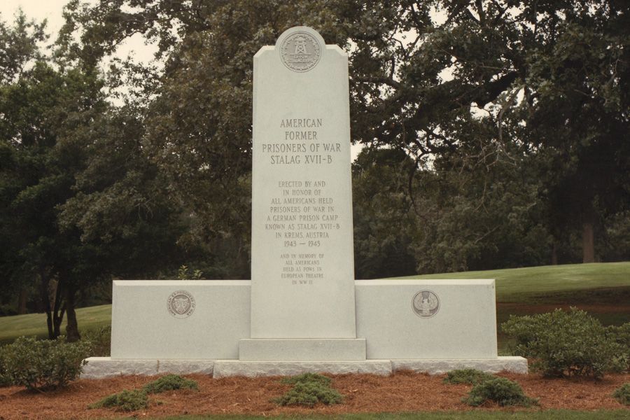 A monument in a park that says ' american forces ' on it