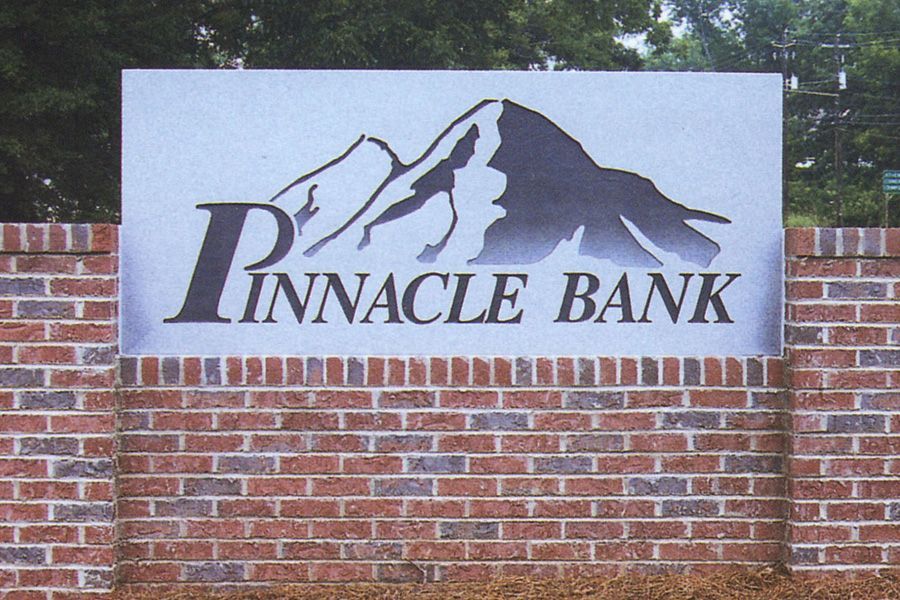 A pinnacle bank sign on a brick wall