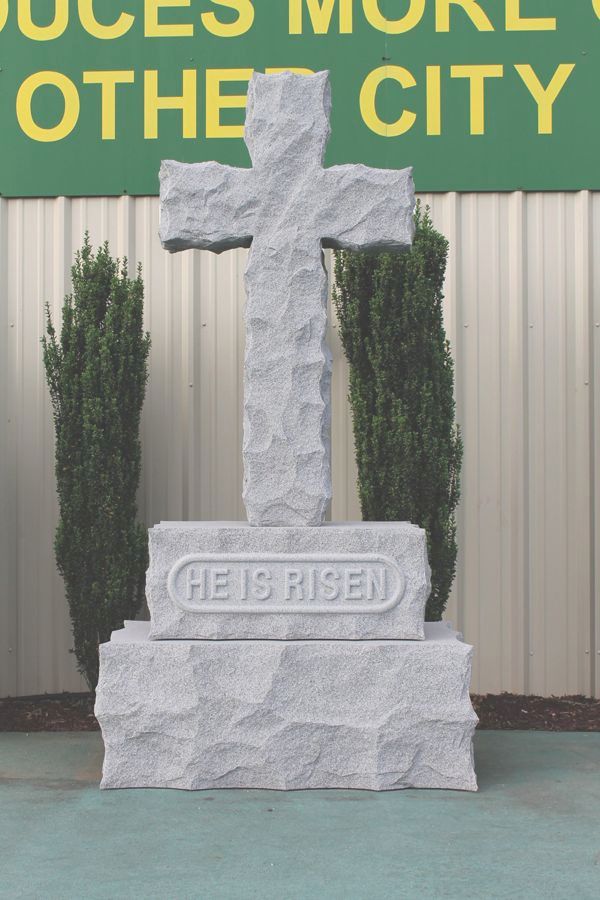 A cross with the words he is risen on it