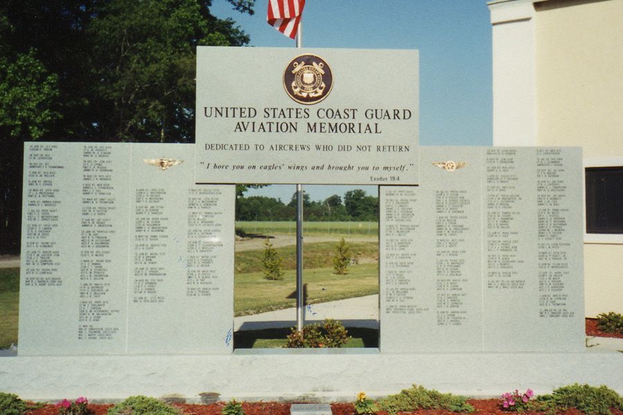 A united states coast guard aviation memorial with a flag in the background