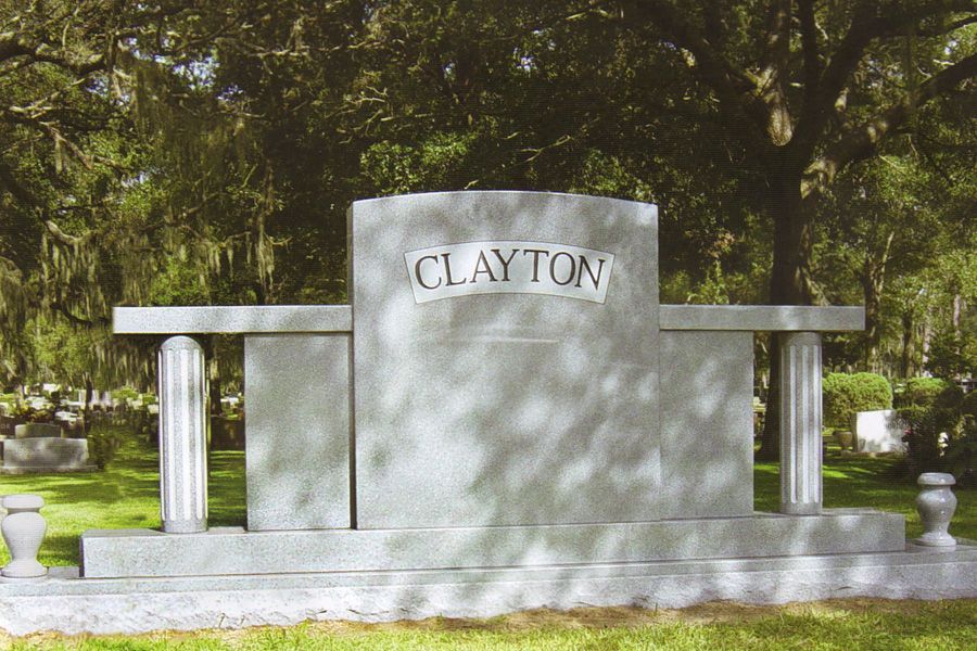 A gravestone for clayton in a cemetery