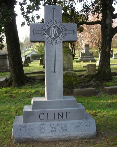 A gravestone with a cross and the name cline on it