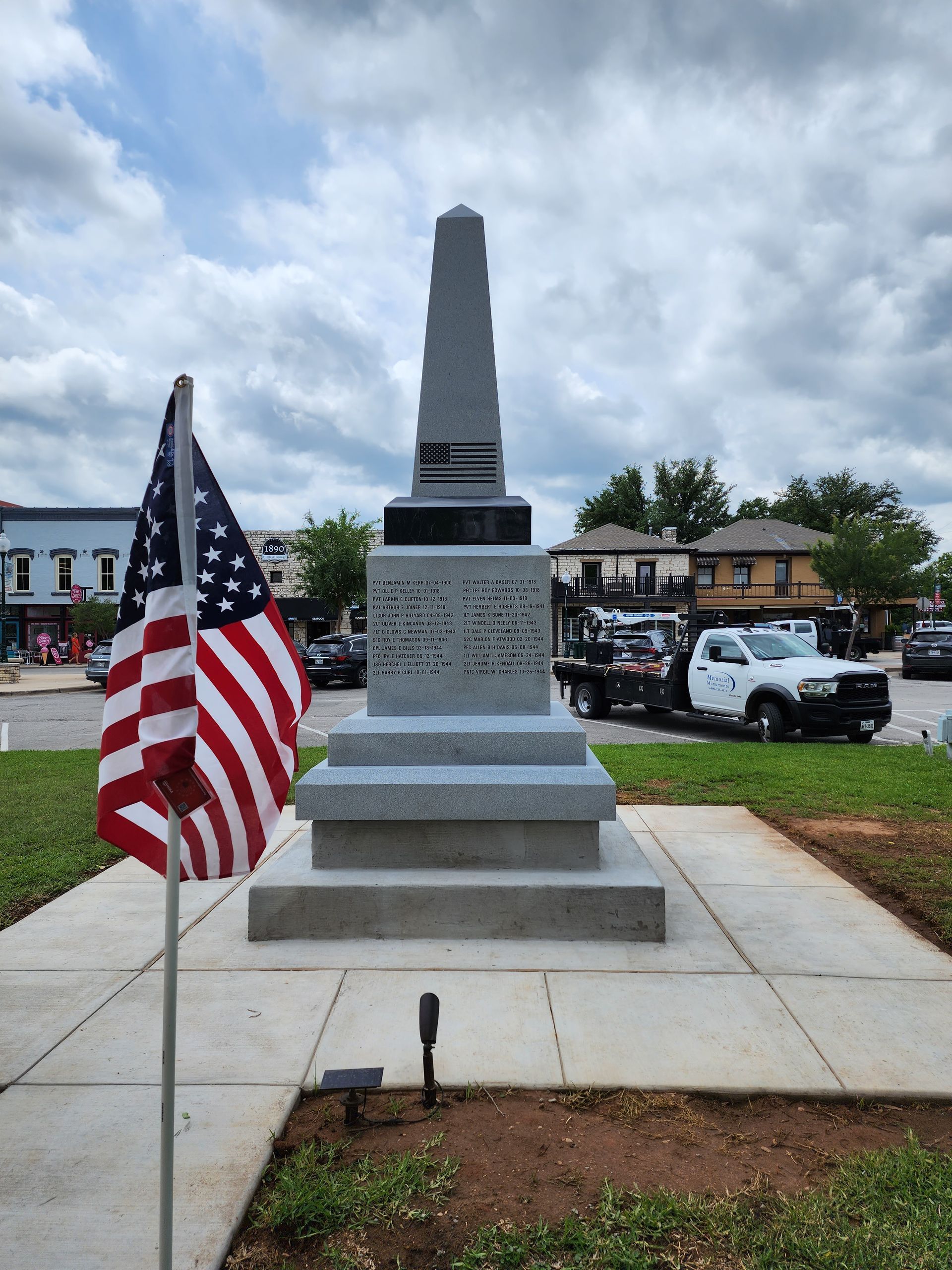 A memorial with an american flag in front of it