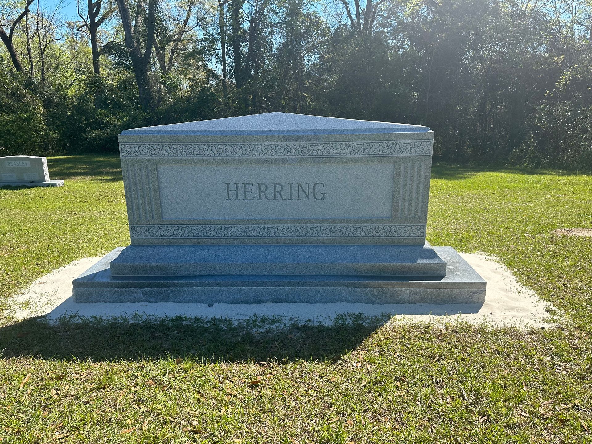 A grave in a cemetery with the name herring on it