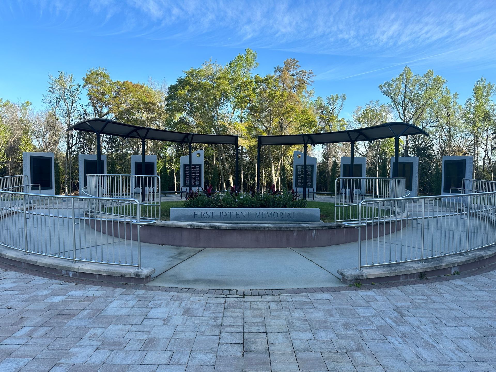 A cemetery with a brick walkway and a fence around it