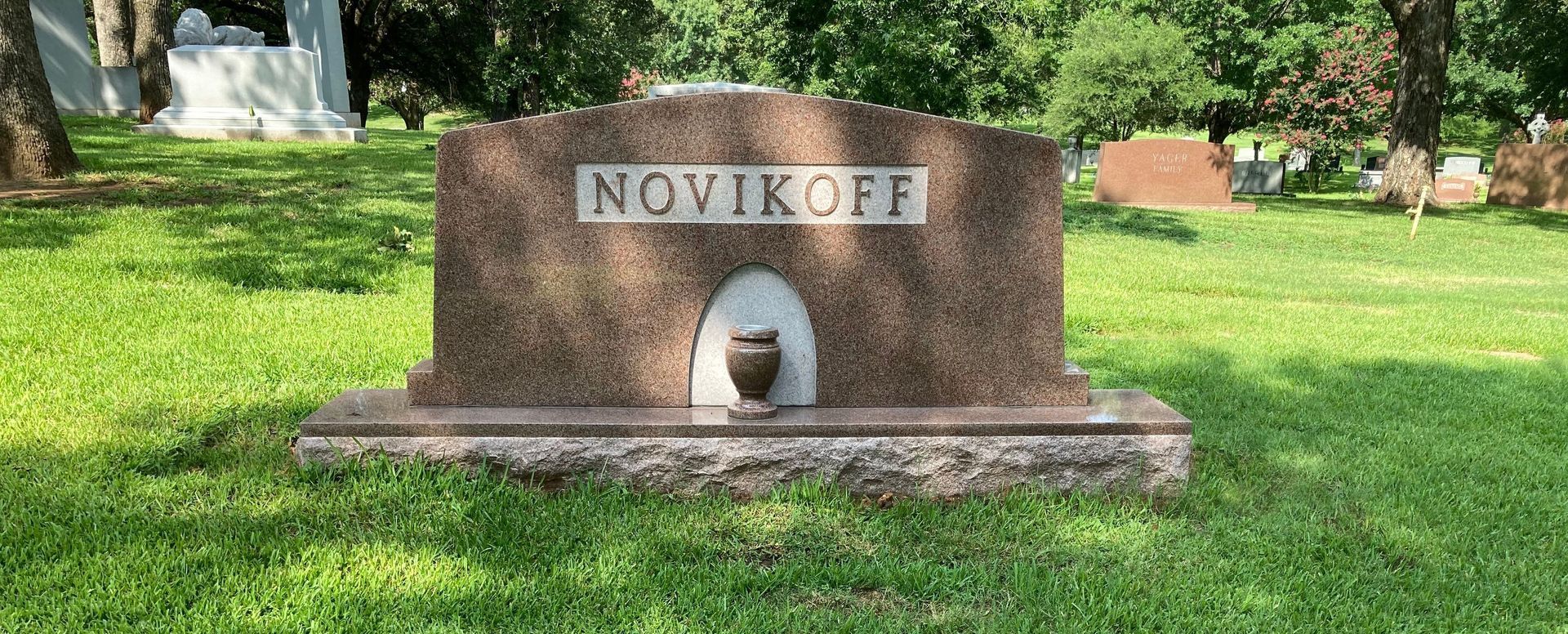 A gravestone in a cemetery with the name novikoff on it.