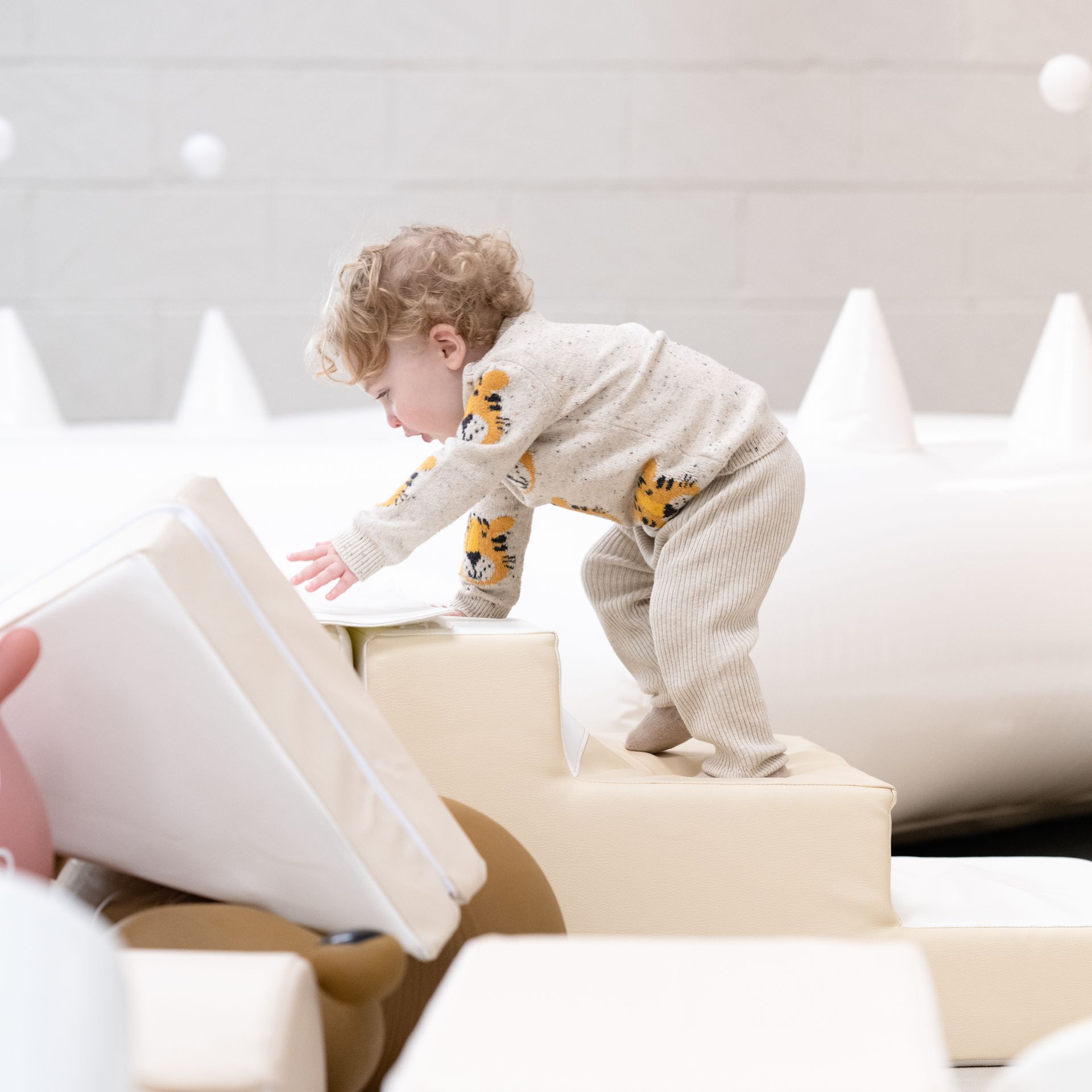baby popping up out of ball pit
