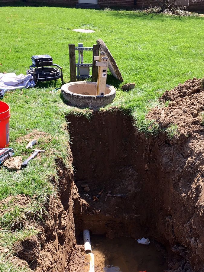 A manhole cover is sitting in the middle of a hole in the ground.