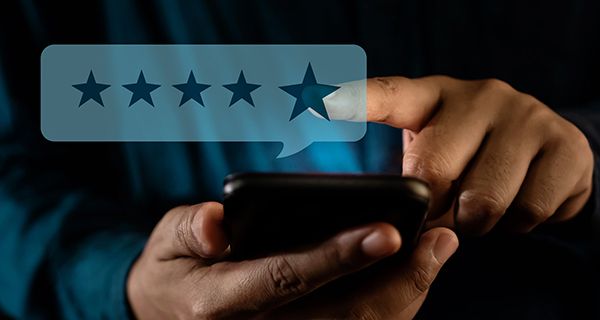 A person is giving a five star rating on a cell phone.