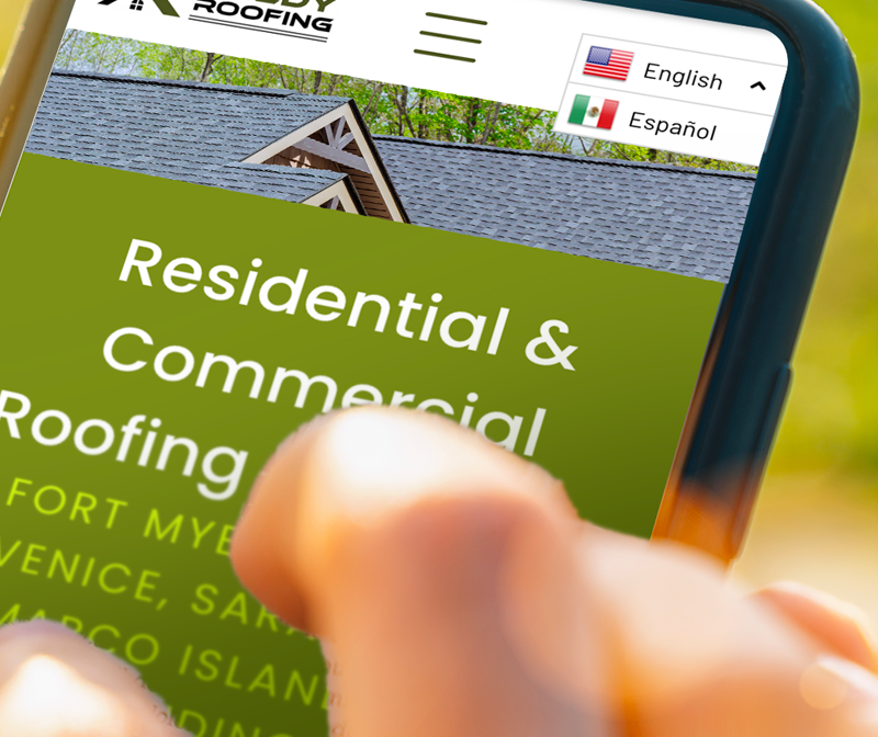 A hand holding a phone displaying a roofing company's website, with language options in English and Spanish.