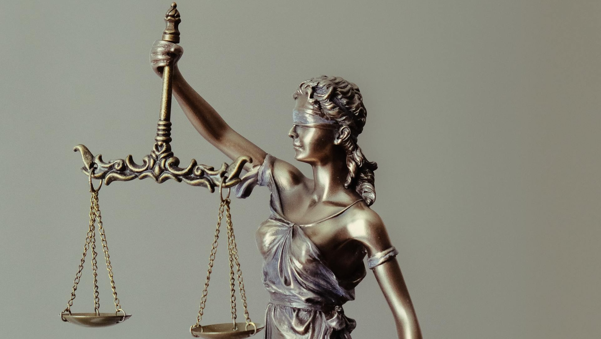 A statue of a woman holding a scale of justice.