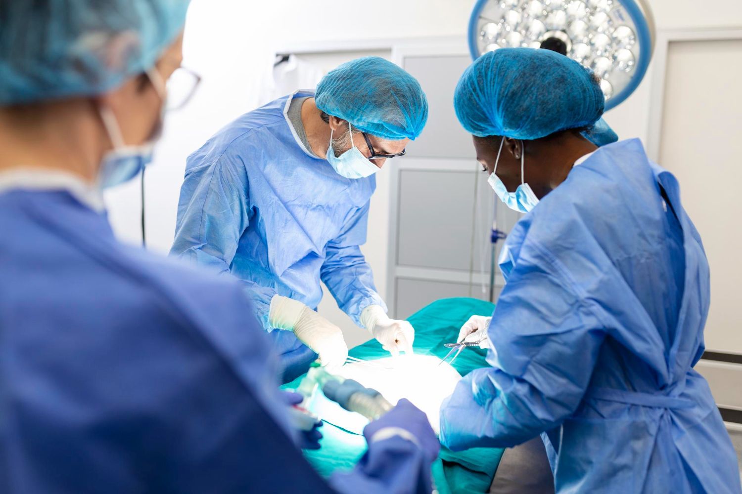 Two surgeons are operating on a patient in an operating room.