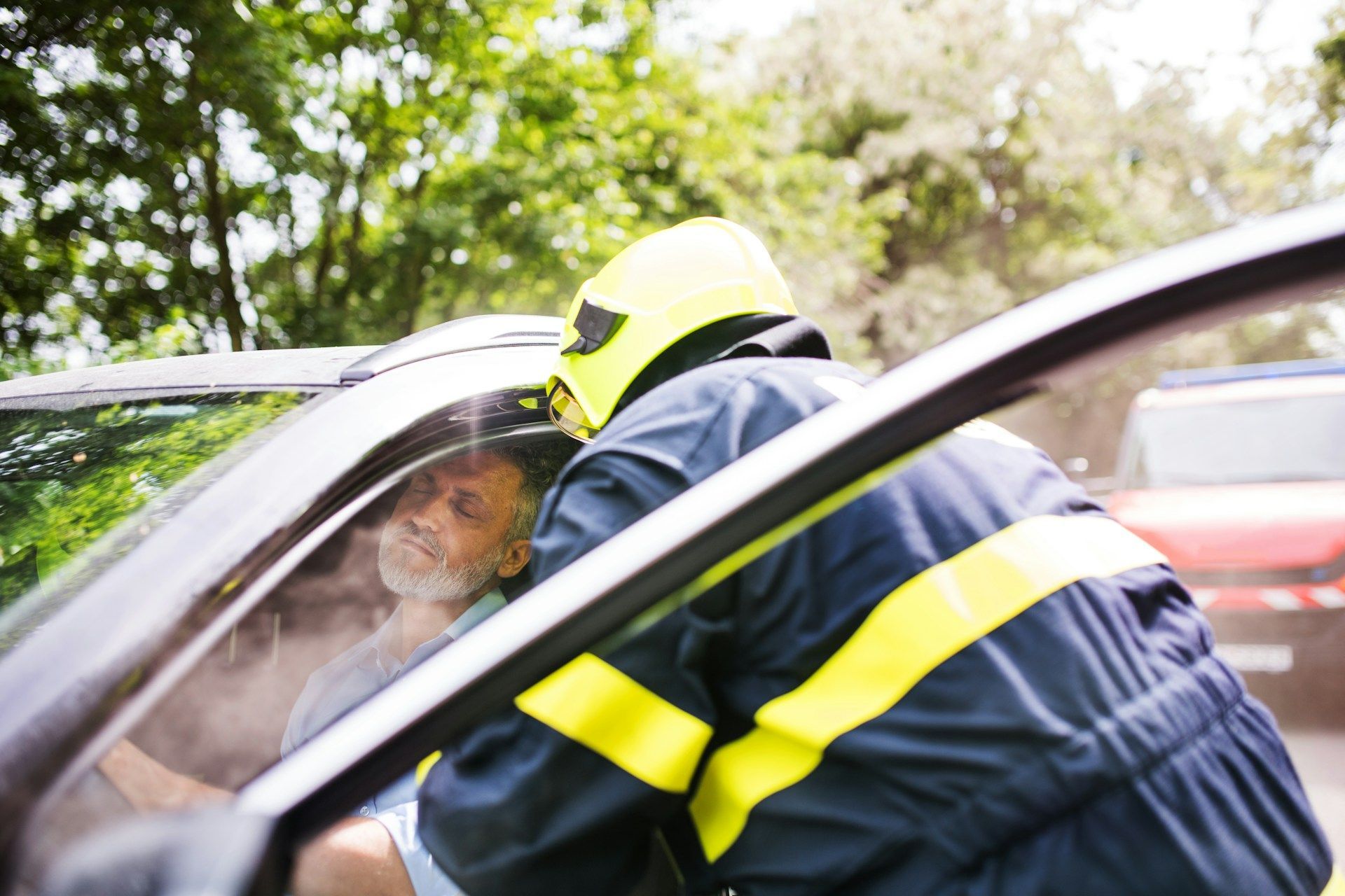 A man is laying in an ambulance with his hands on his chest.