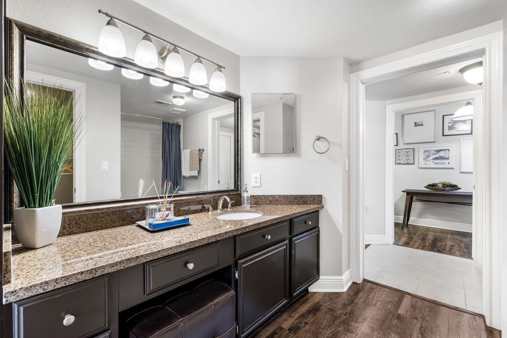 a bathroom with two sinks and a large mirror at Marquis on Pin Oak in Houston, TX.