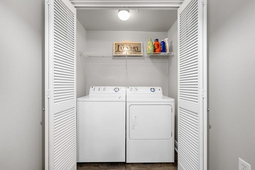 a laundry room with a washer and dryer in a closet at Marquis on Pin Oak in Houston, TX.
