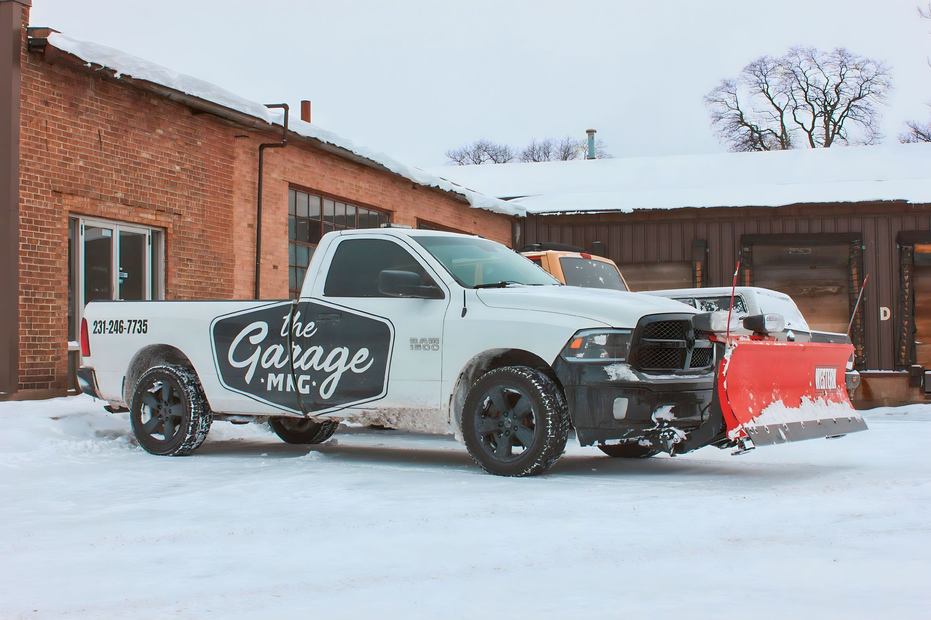 White pickup truck with snow plow, logo for 