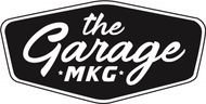 Logo for "The Garage MKG" in white script on a black hexagon with white border.