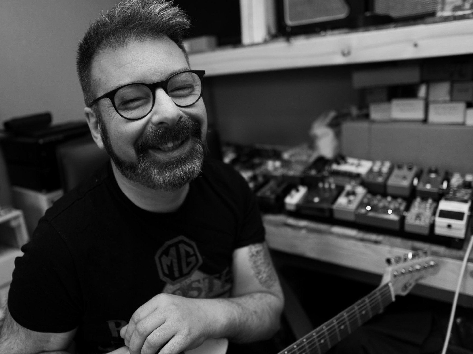 man with beard and glasses laughing