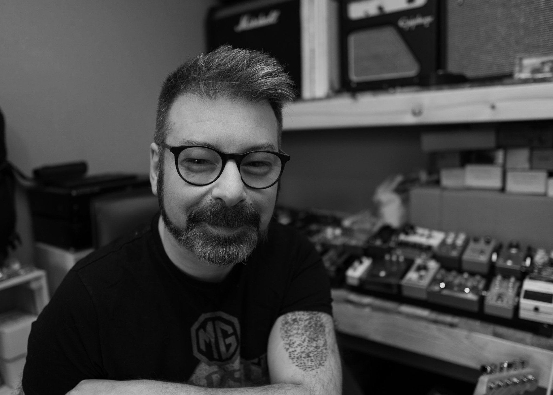 man with beard and glasses leaning towards camera