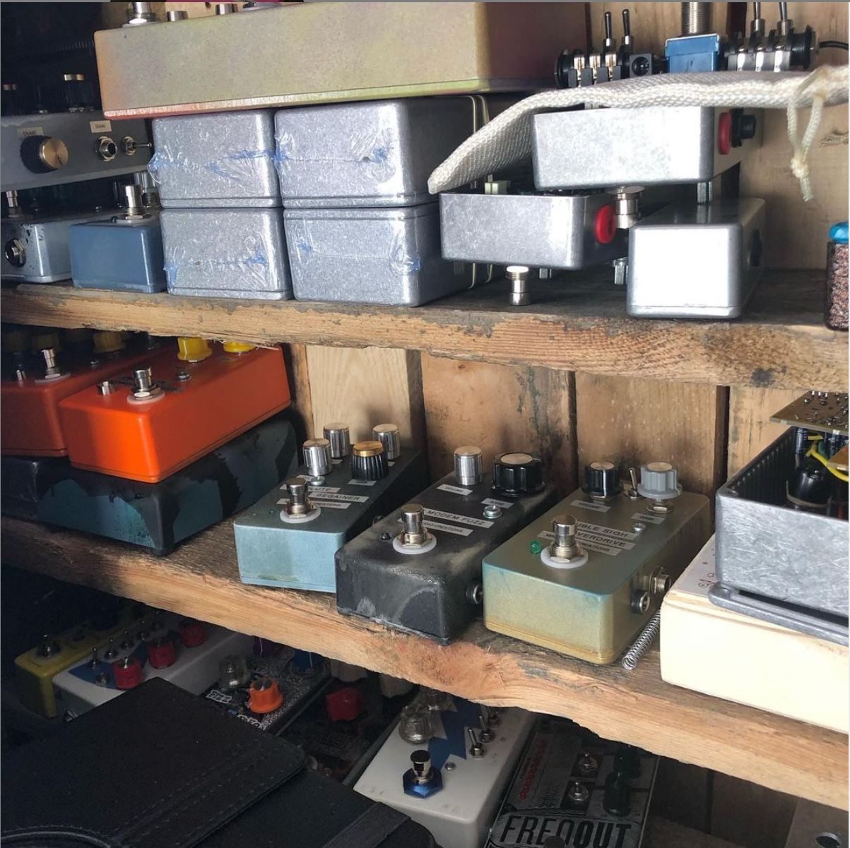 guitar pedals on a shelf