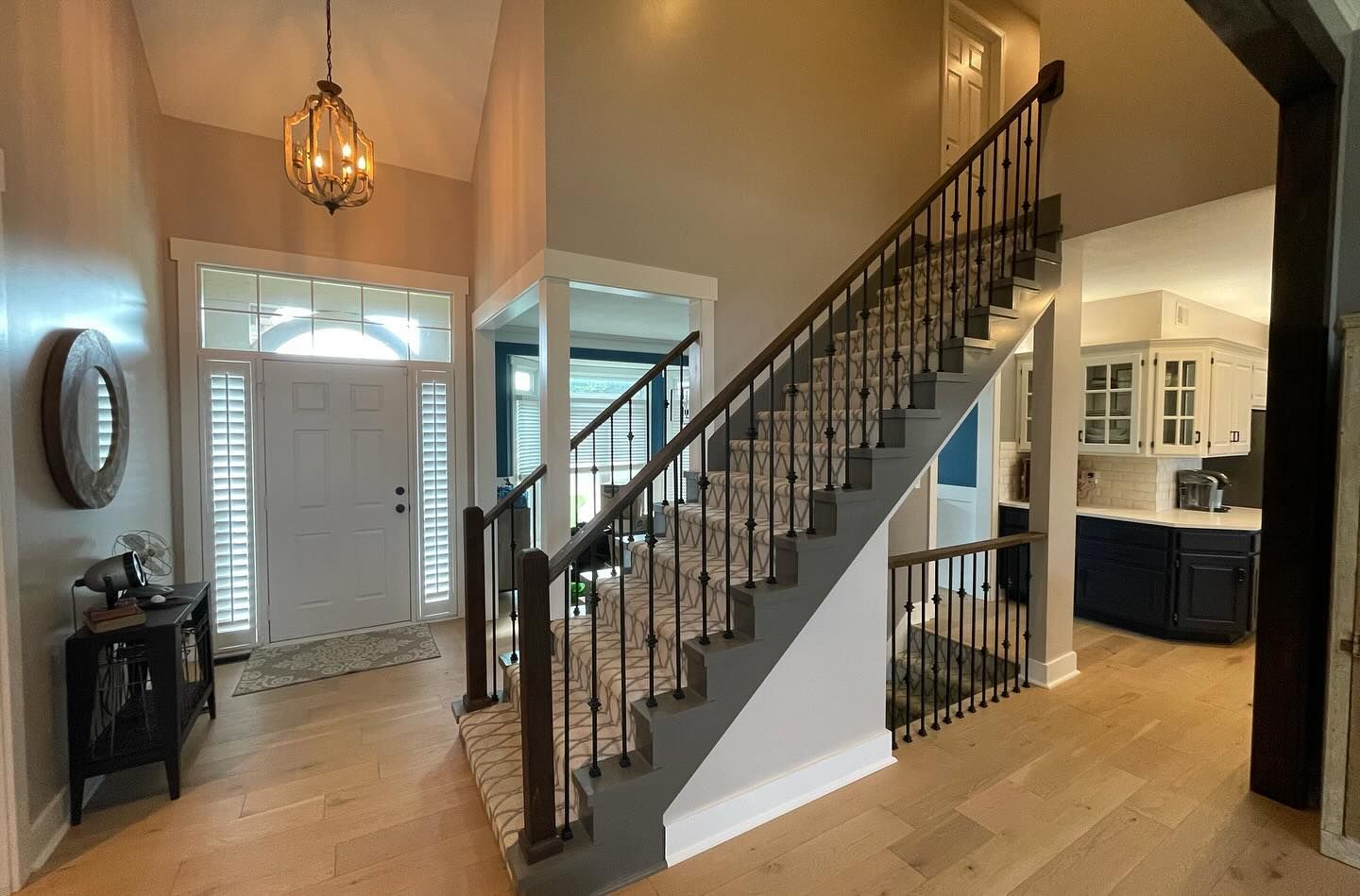 A hallway with stairs leading up to the second floor of a house.