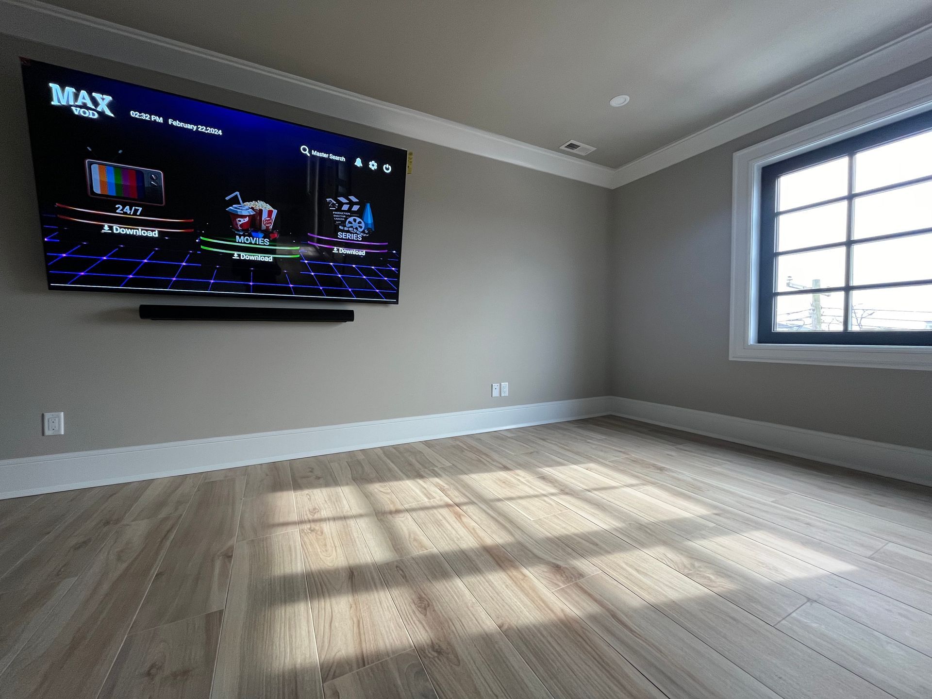 A large flat screen tv is hanging on the wall in a living room.
