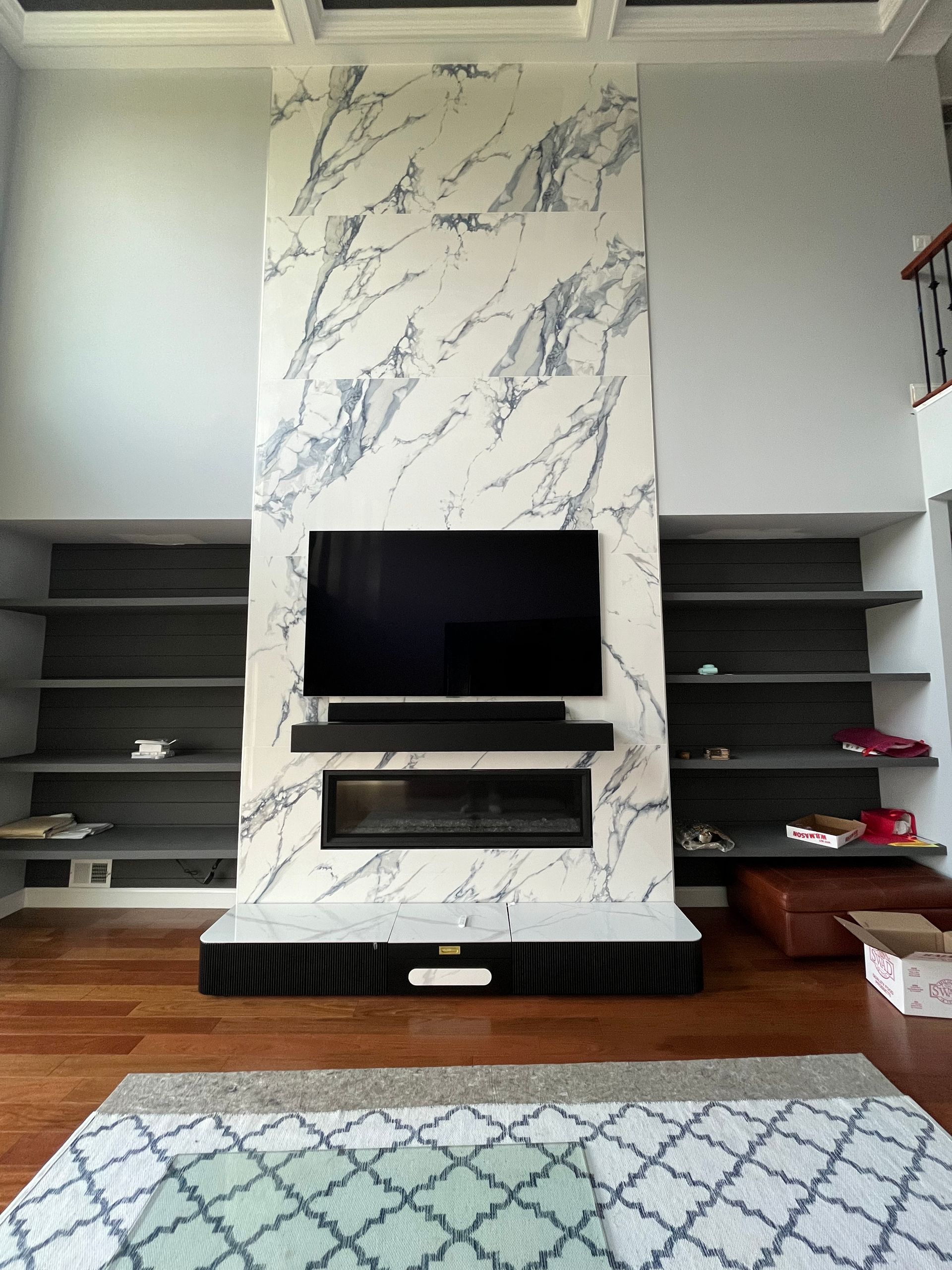 A living room with a fireplace and a flat screen tv