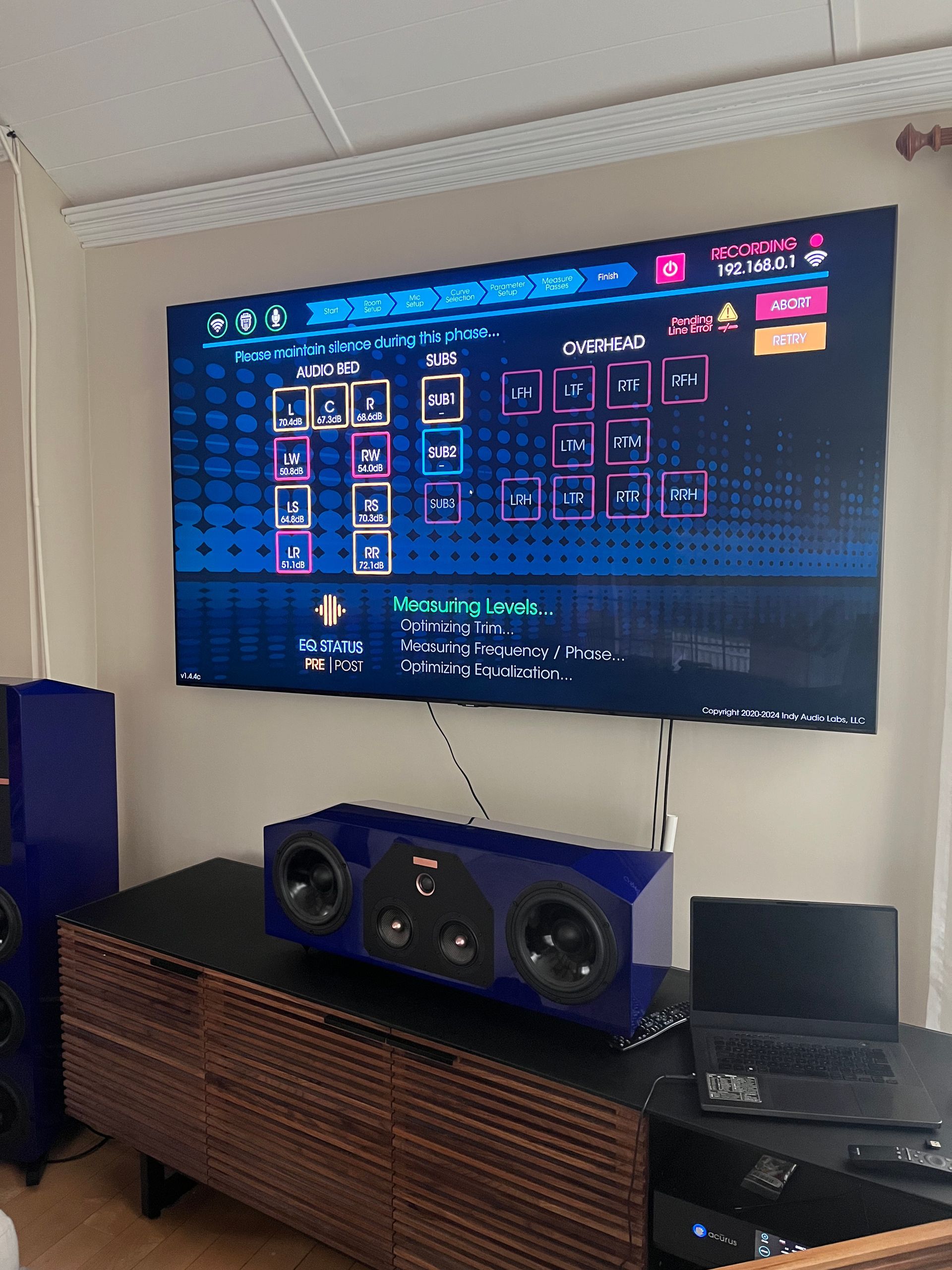 A living room with a flat screen tv and speakers