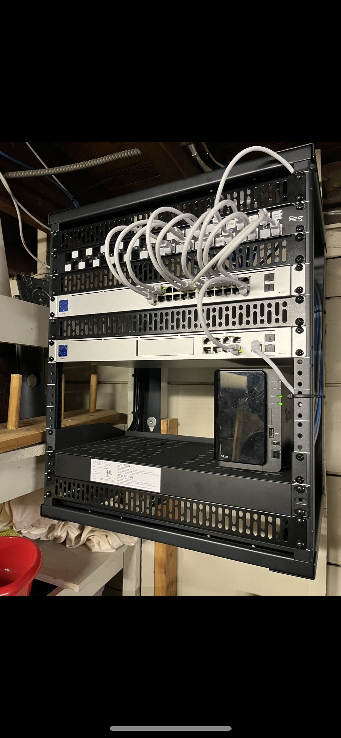 A server rack with a lot of wires hanging from it.