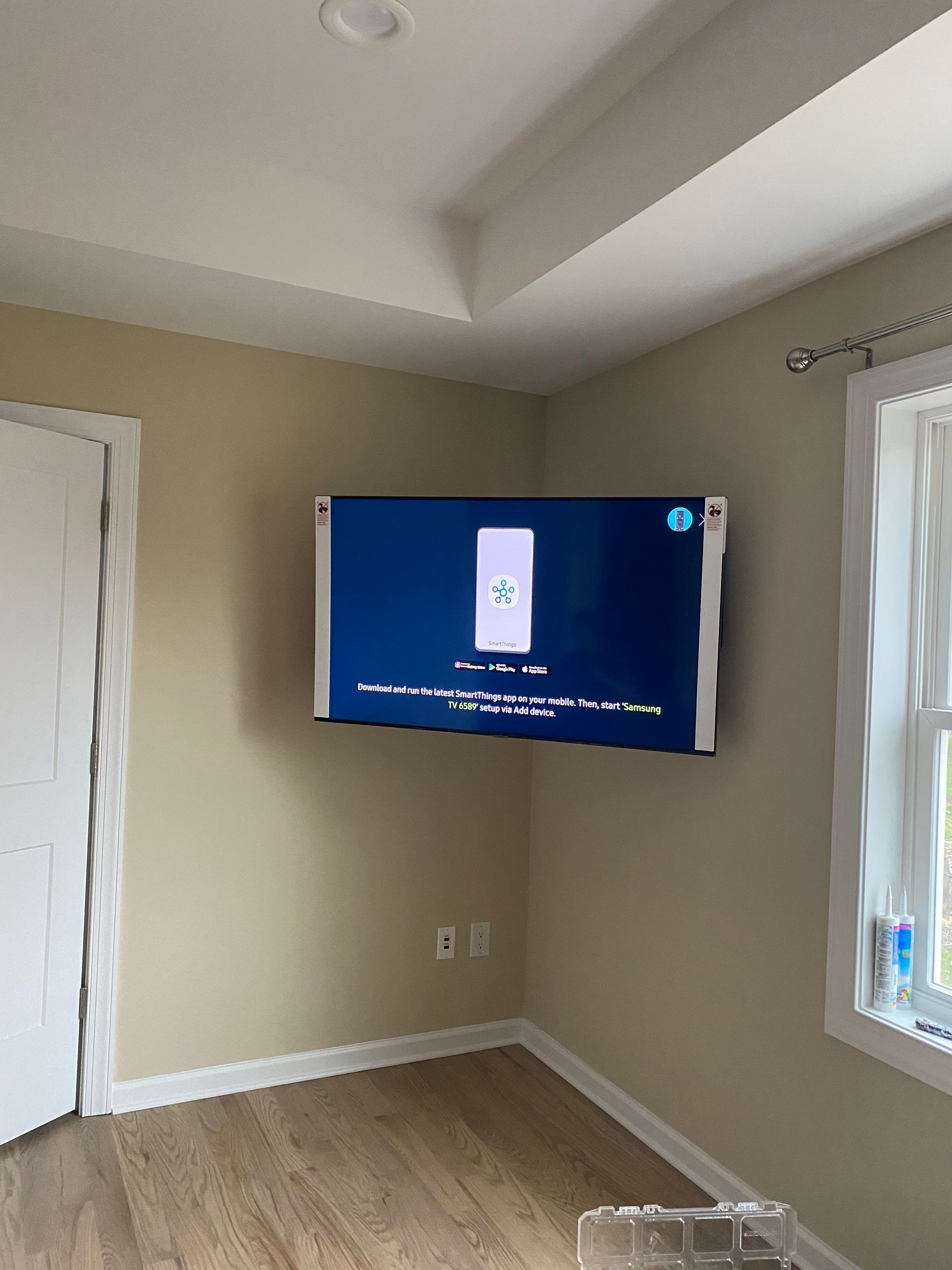A flat screen tv is mounted on a wall in a living room.