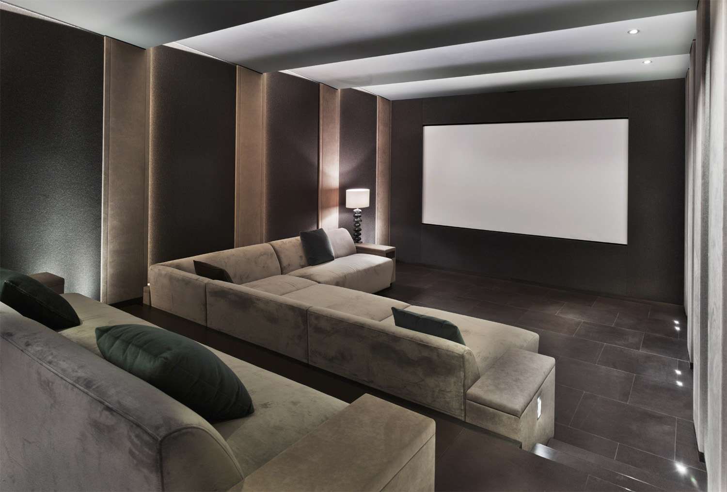 A living room with a couch and a projector screen