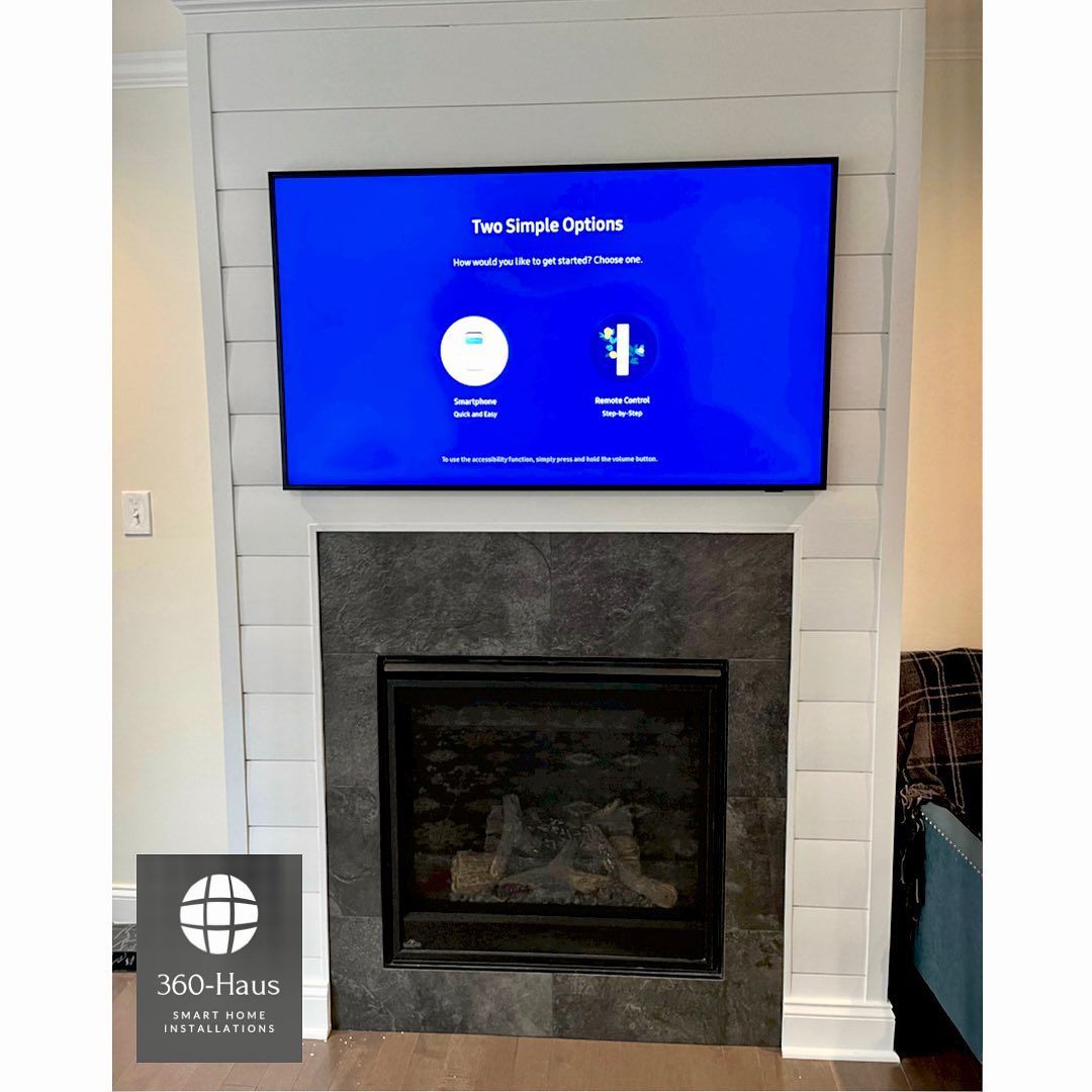 A flat screen tv is mounted above a fireplace in a living room.