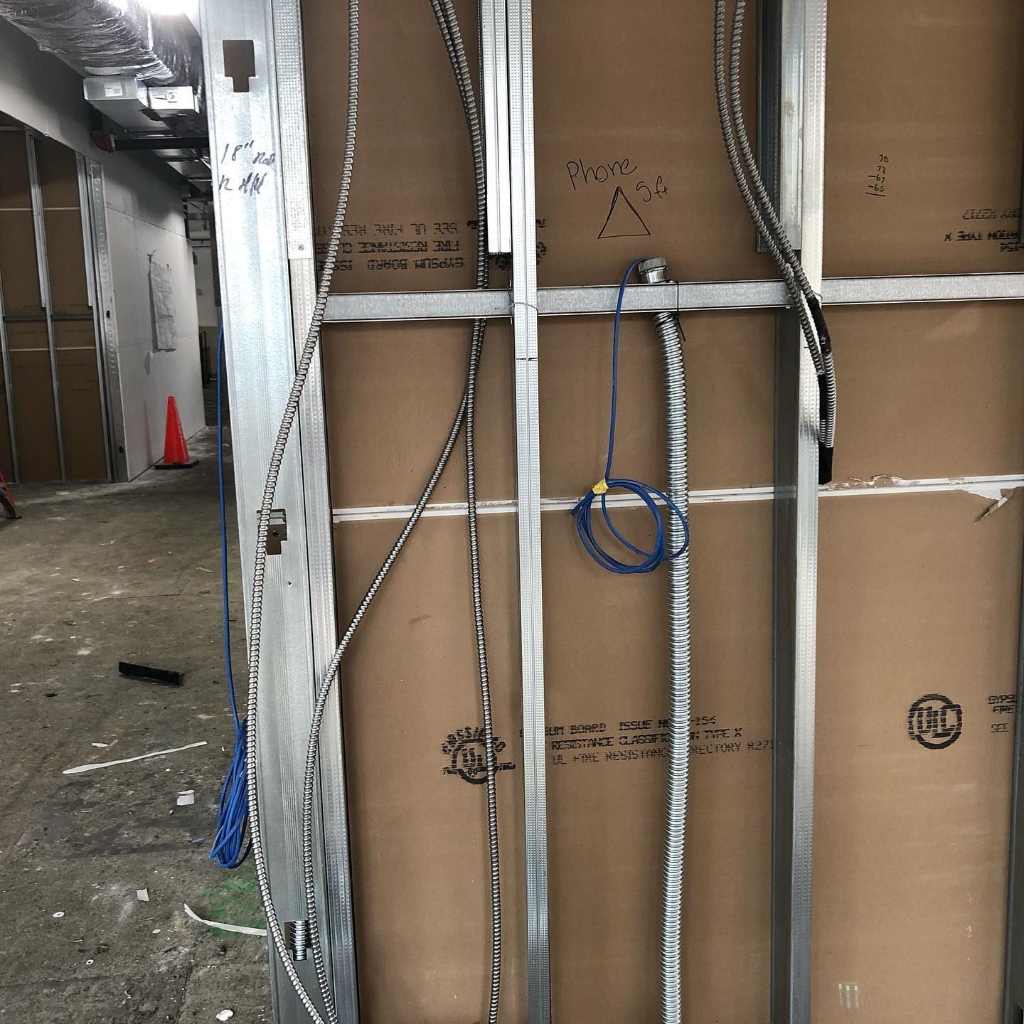 A wall with a lot of wires coming out of it