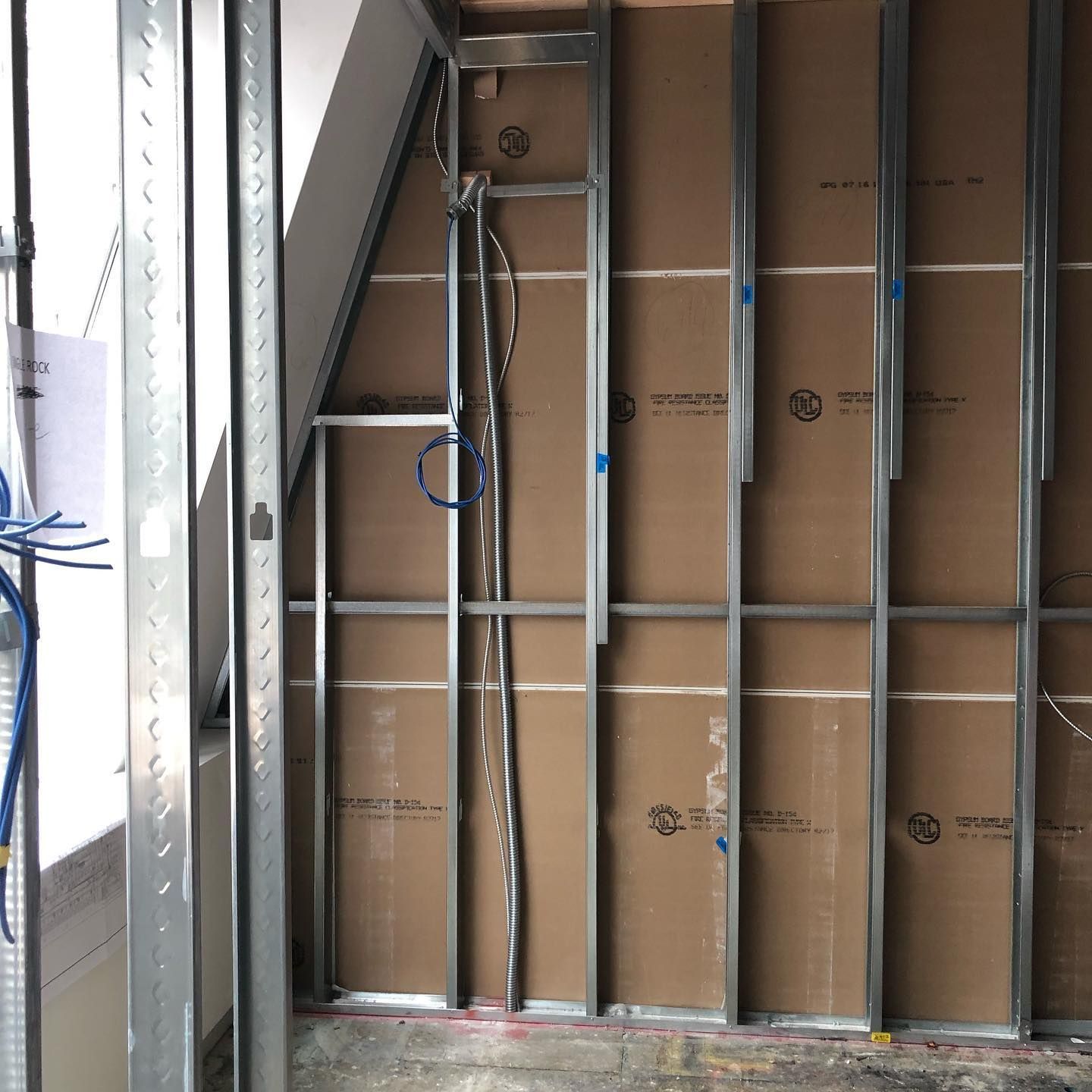 A ladder is hanging from the side of a wall