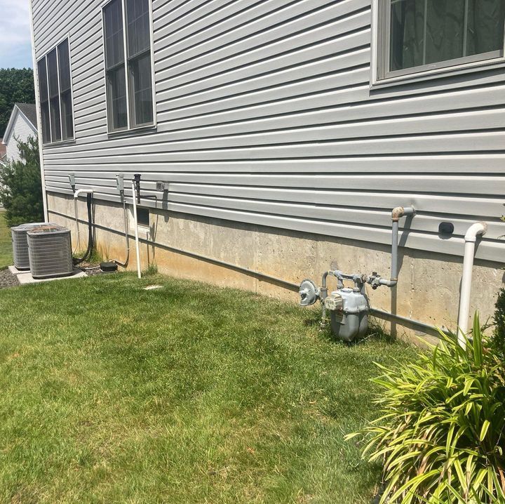 A house with a lot of pipes on the side of it.