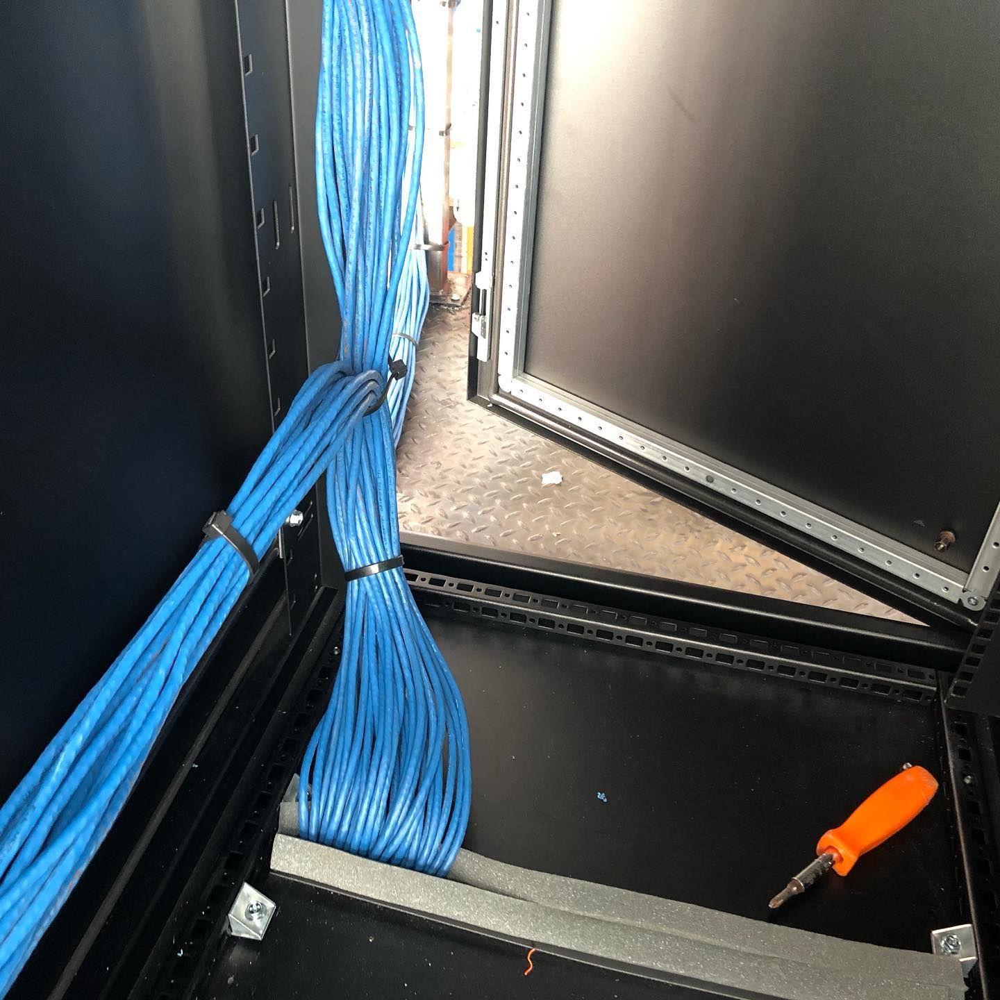 A bunch of blue wires are tied together in a black box