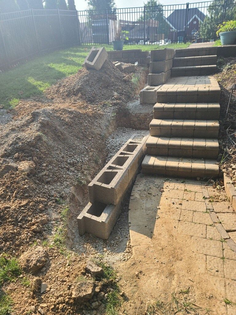 A staircase is being built in a backyard.