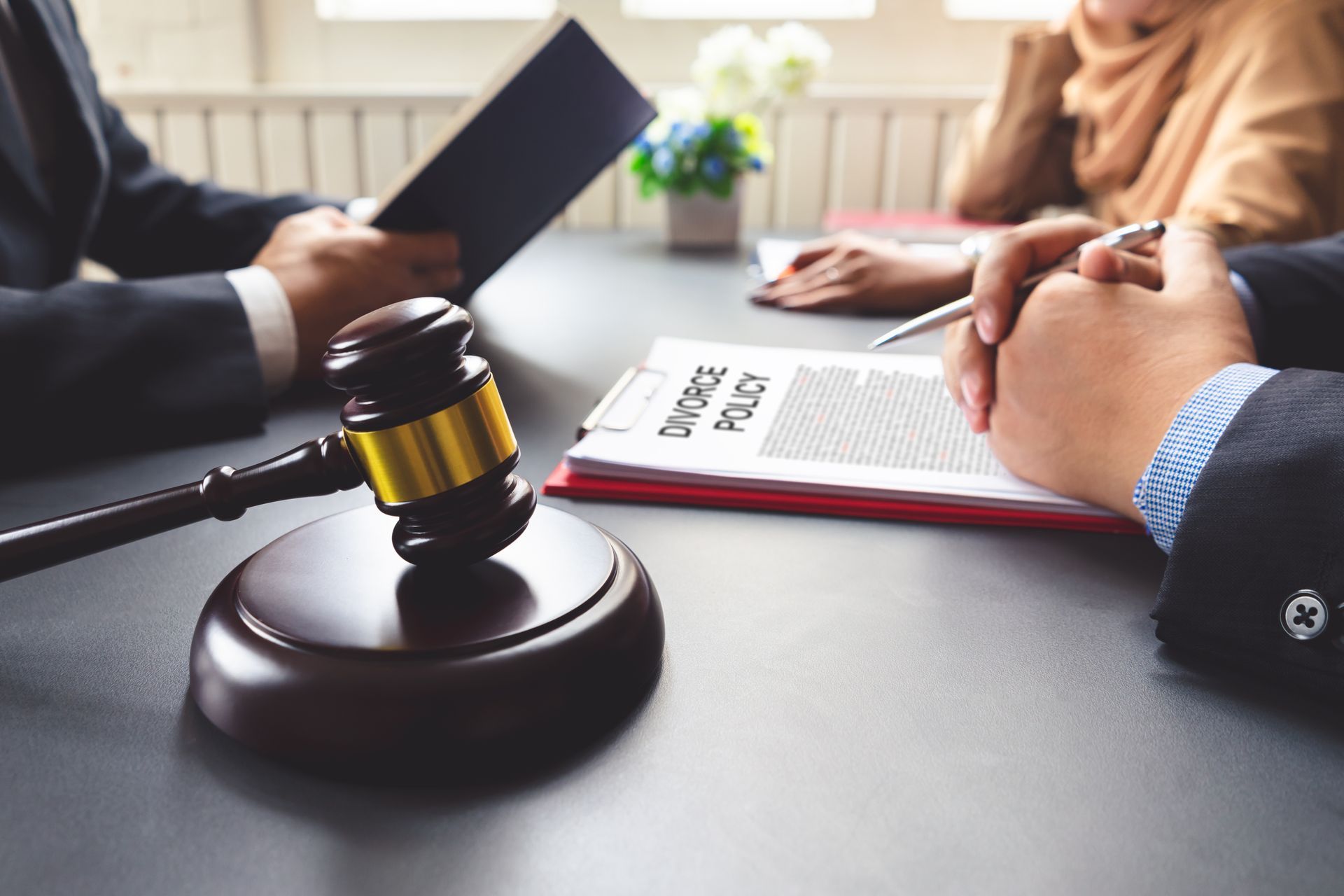 A couple consulting a lawyer about a divorce agreement.