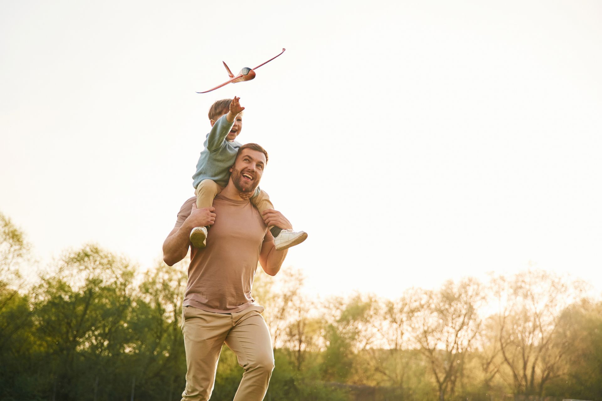 Father Playing With His Son and a Toy Airplane In Mid Air | Mount Eliza, VIC | Lawyers by the Bay